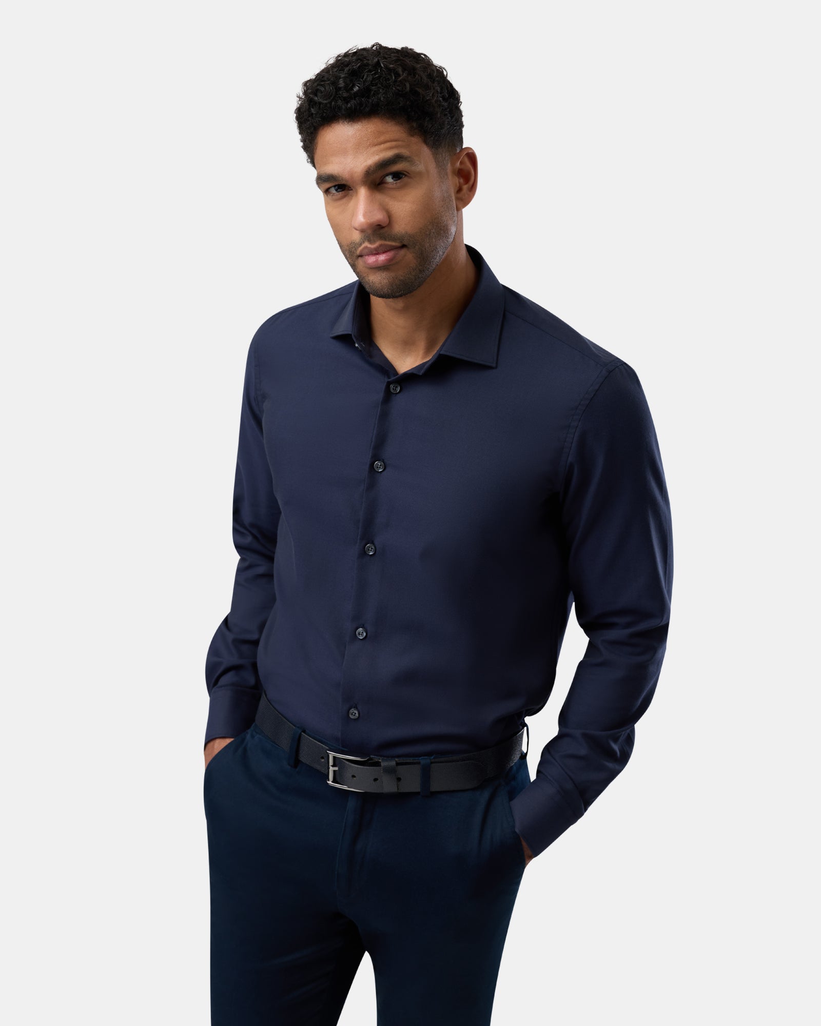 Front perspective of man wearing a navy easy-care regular-fit shirt