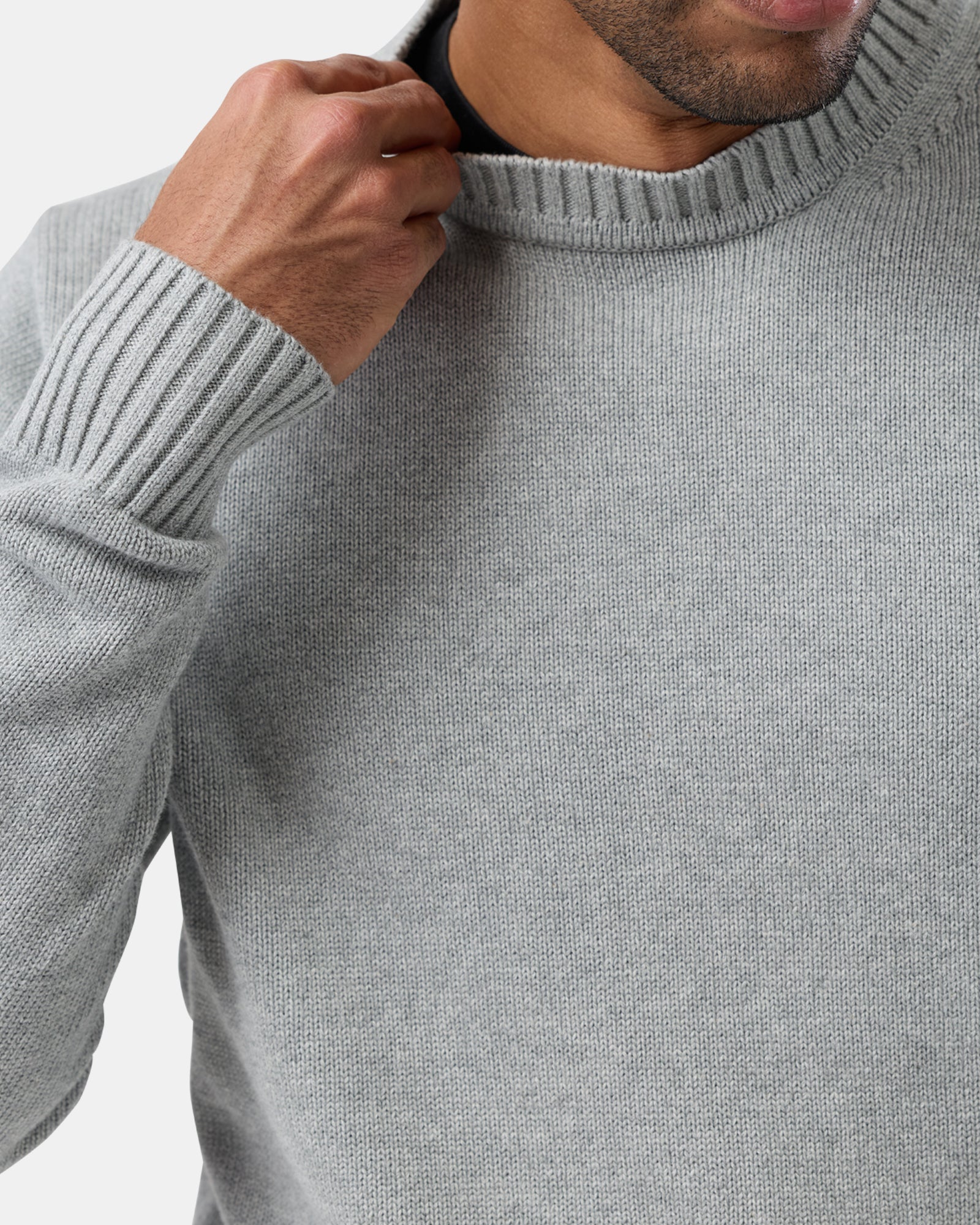 Close-up of a person wearing a gray sweater