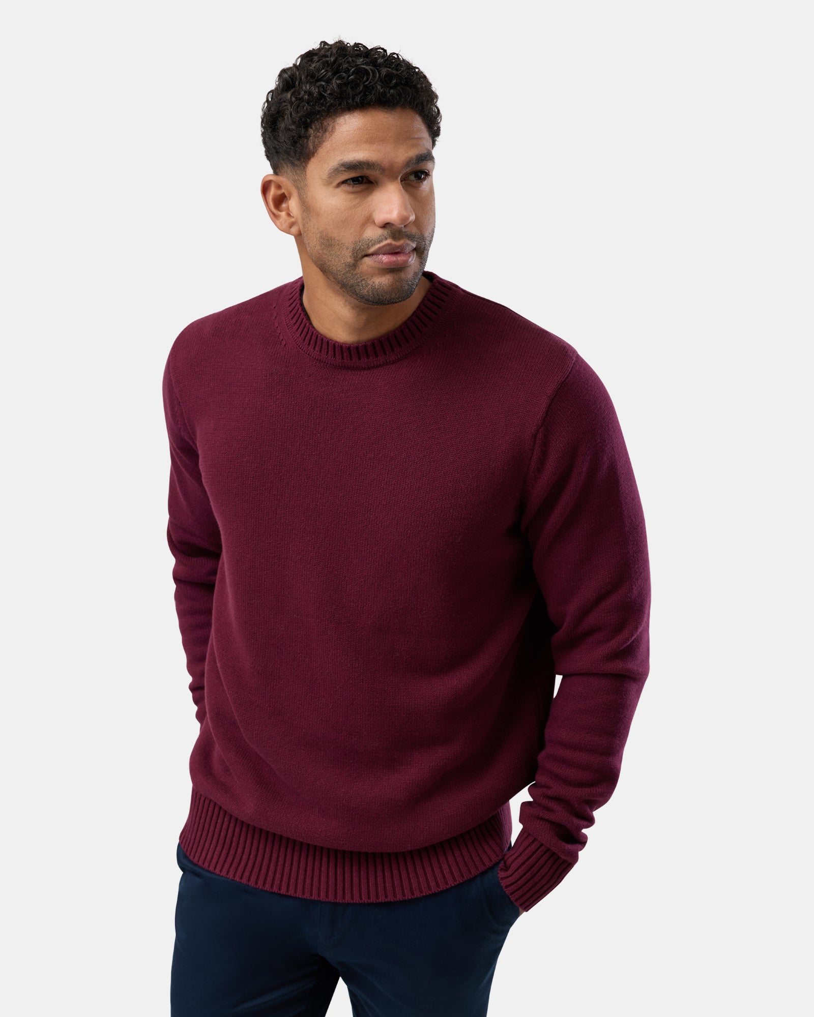 Male, in maroon crew neck sweater
