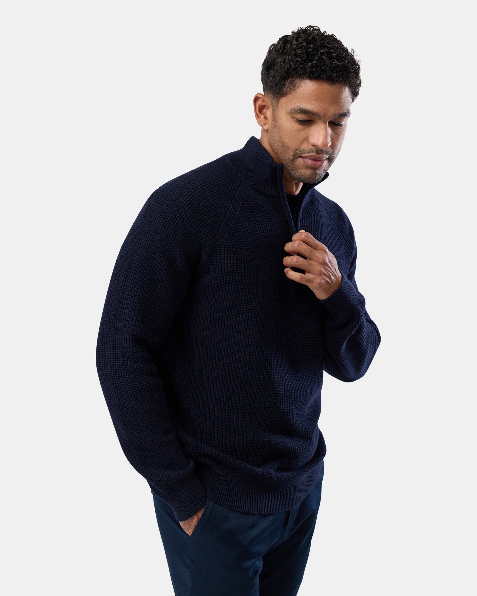 Male in navy half zip knit