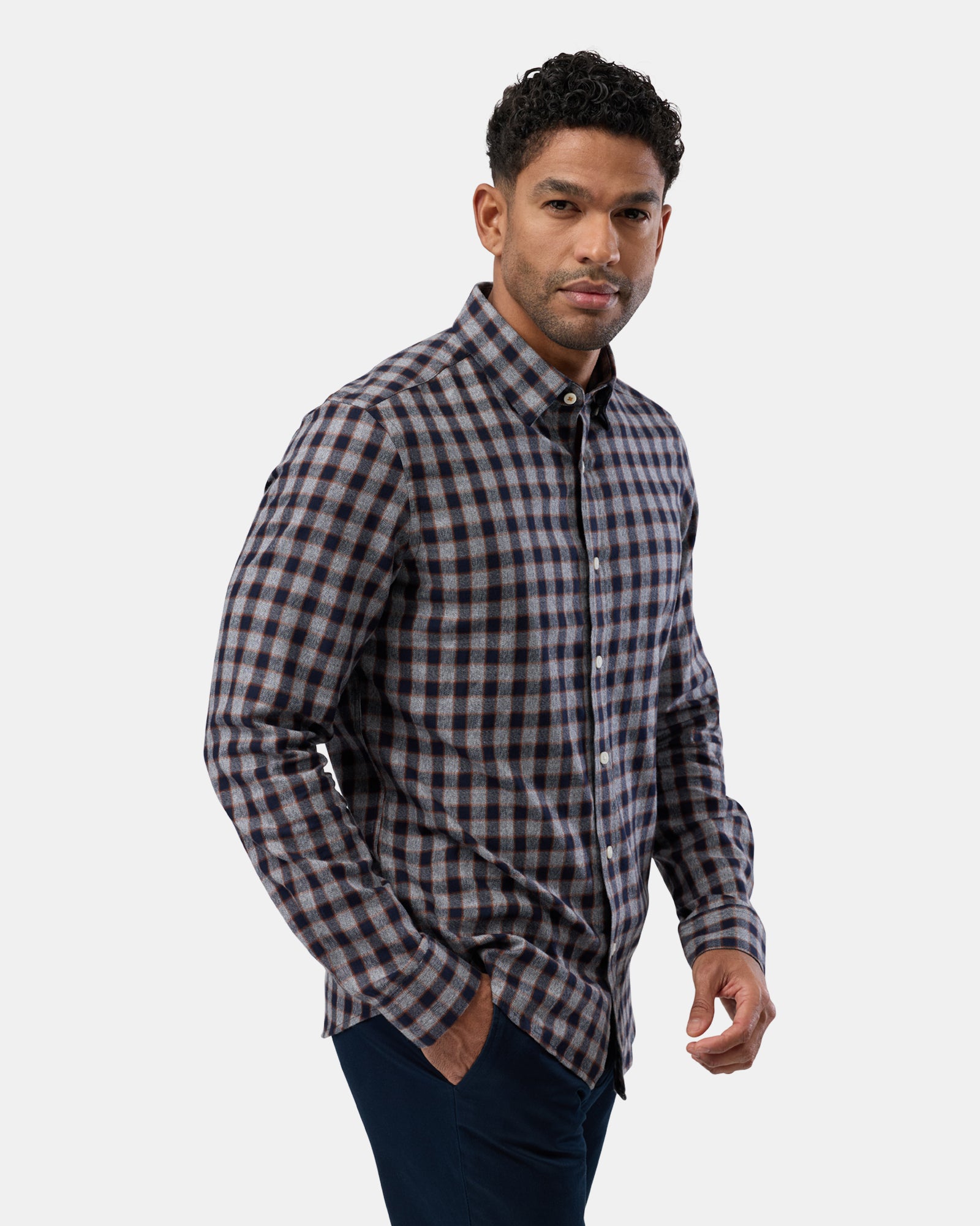 Profile of man wearing grey patterned casual shirt