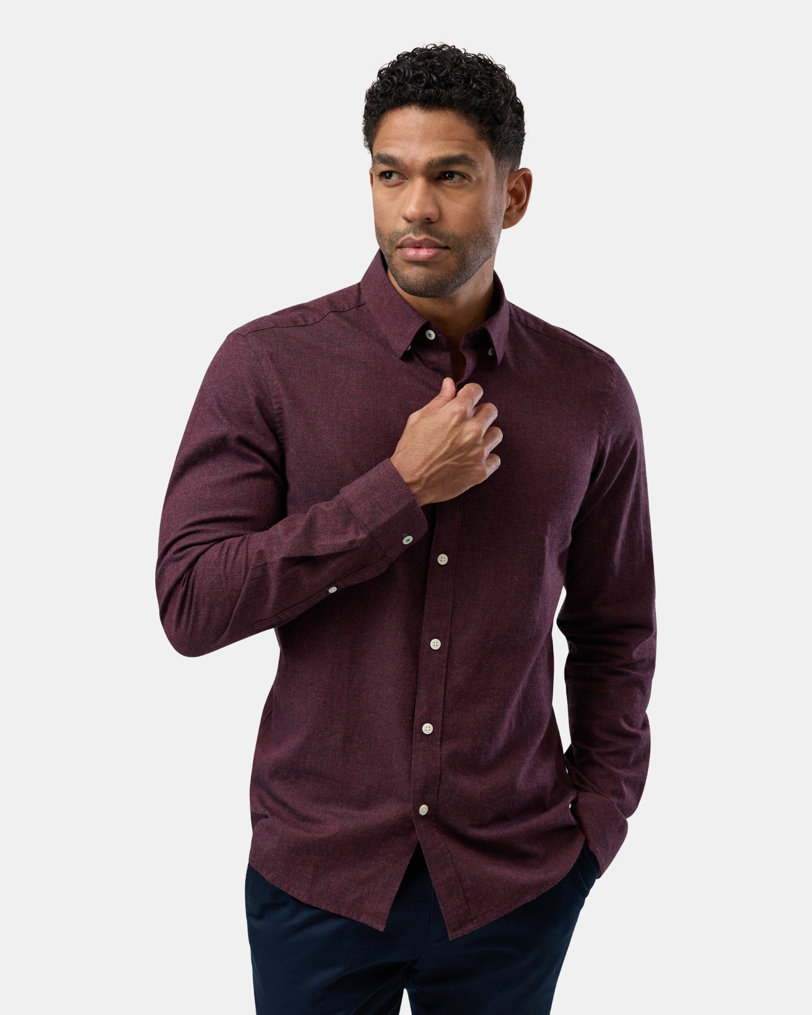 Front view of man wearing burgundy long sleeve casual shirt, relaxed fit