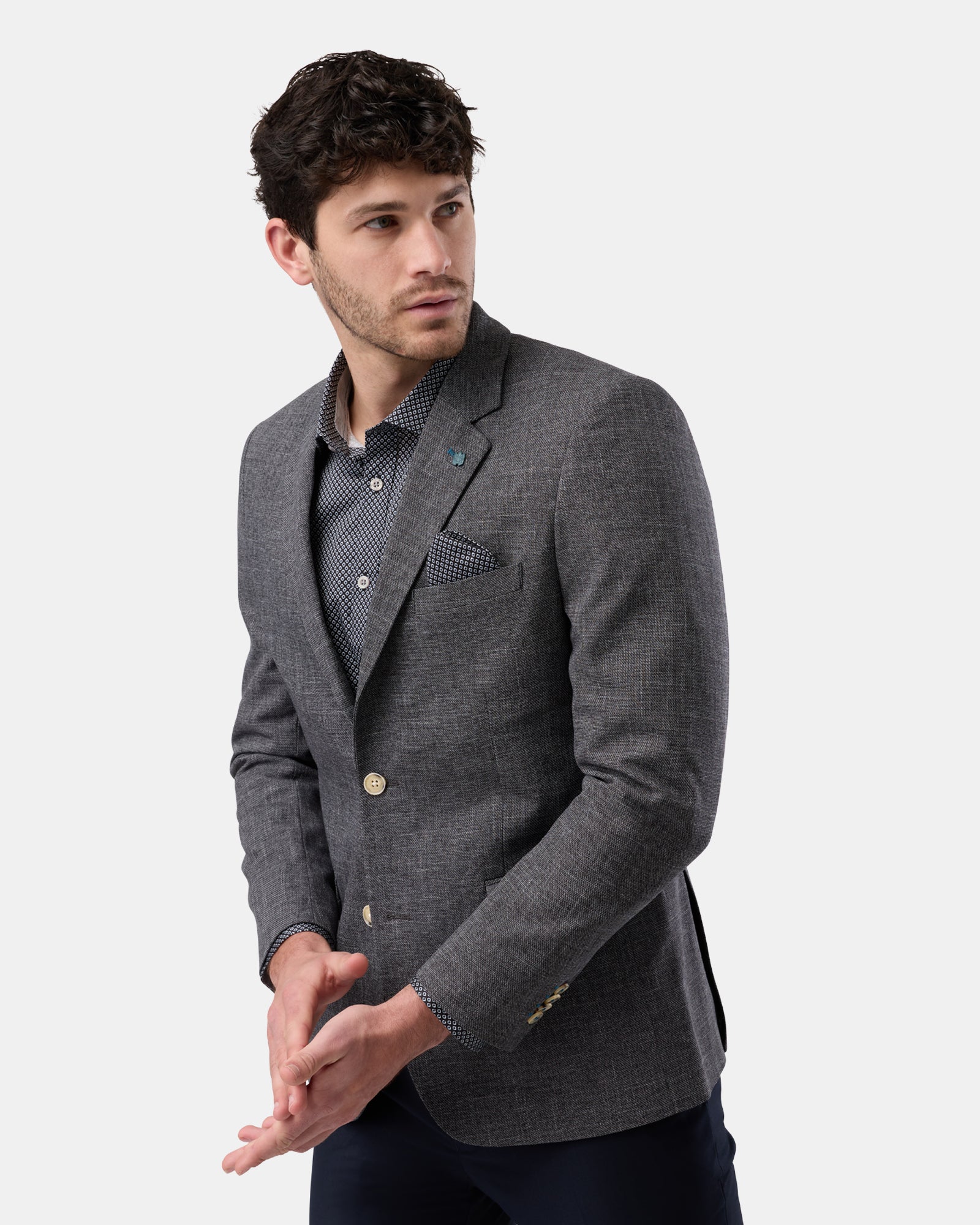 Side angle of black blazer, structured design with sharp lines