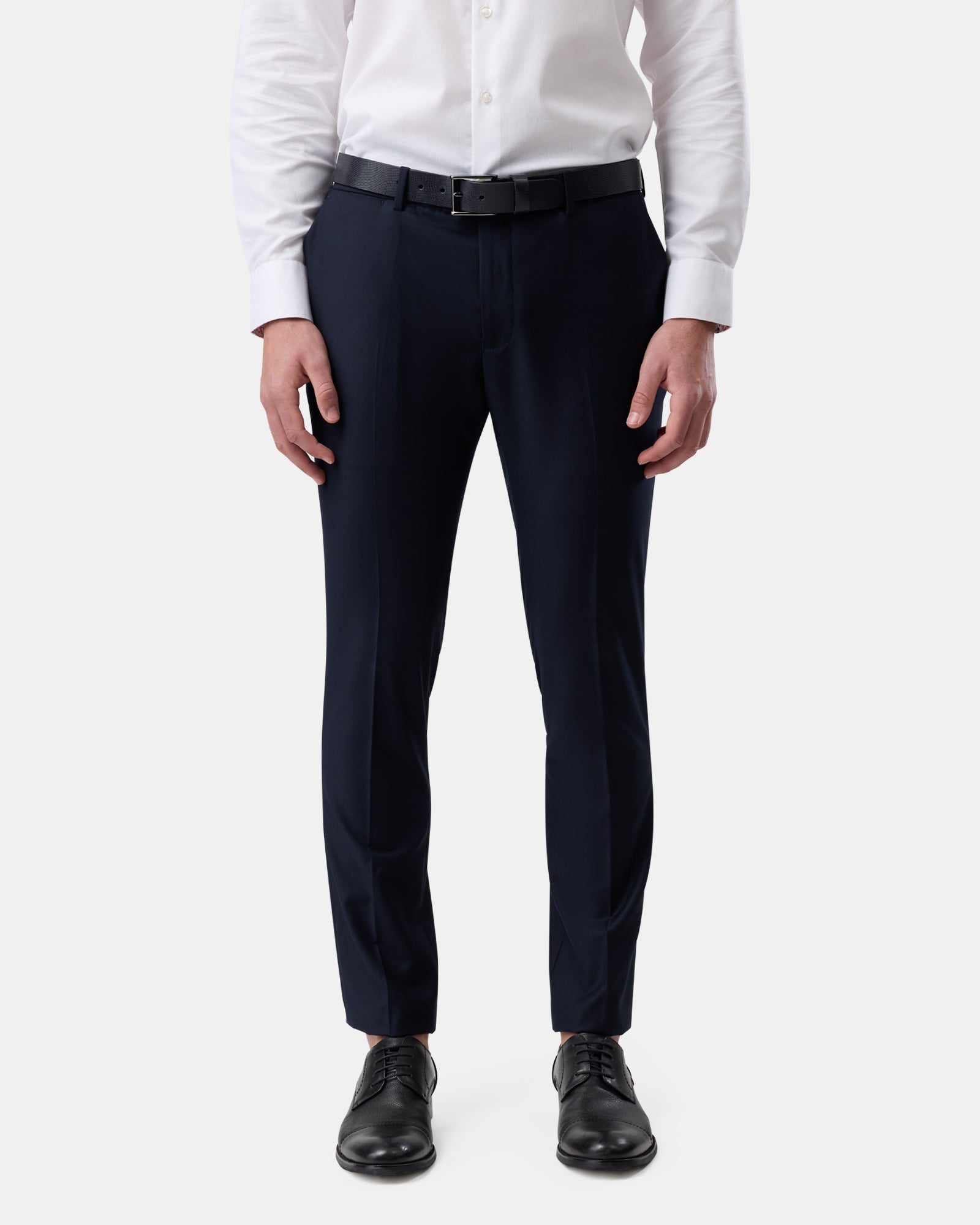 Front view of man wearing navy tailored trousers, slim fit