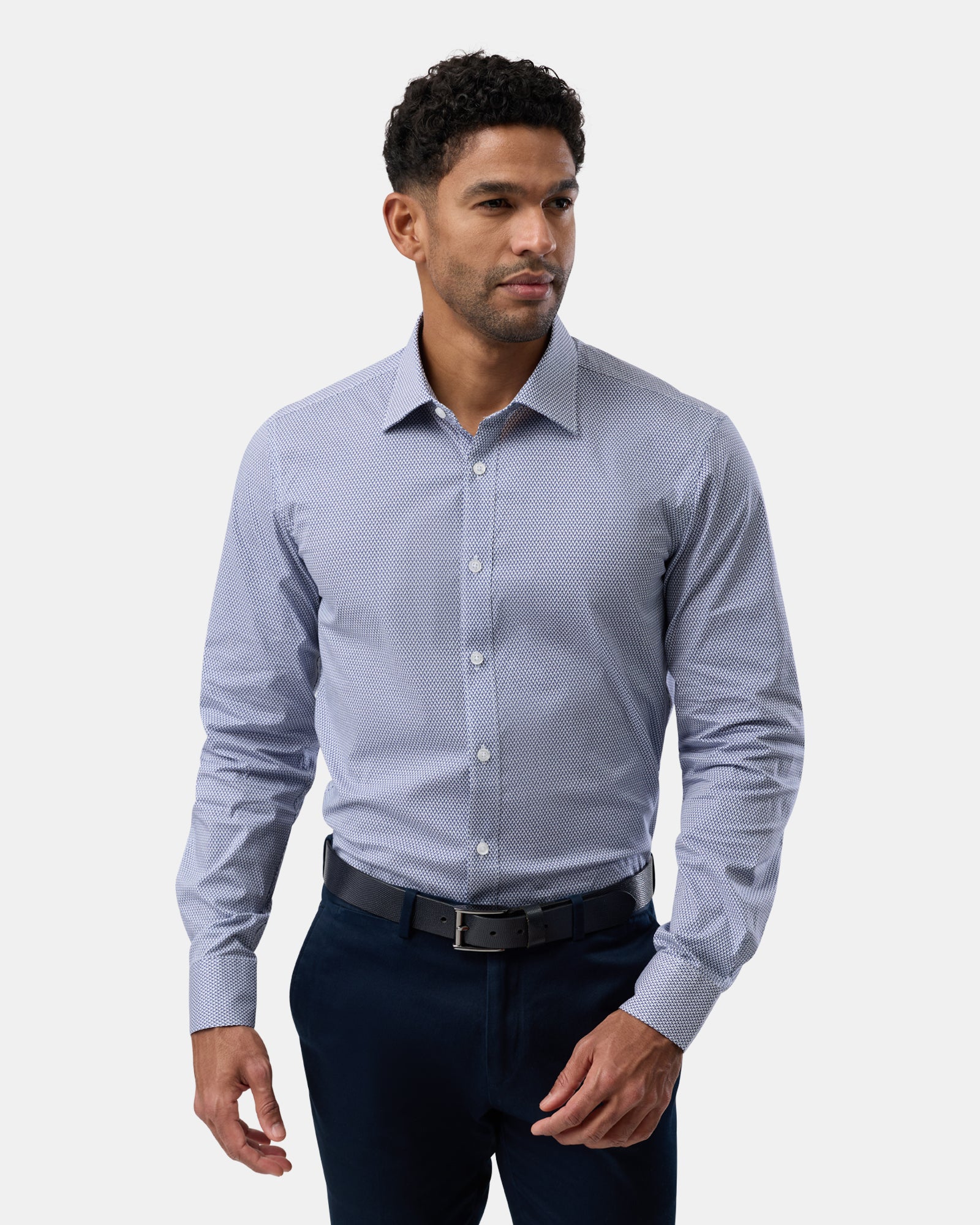Man wearing blue geometric stretch performance regular-fit shirt, viewed from the front
