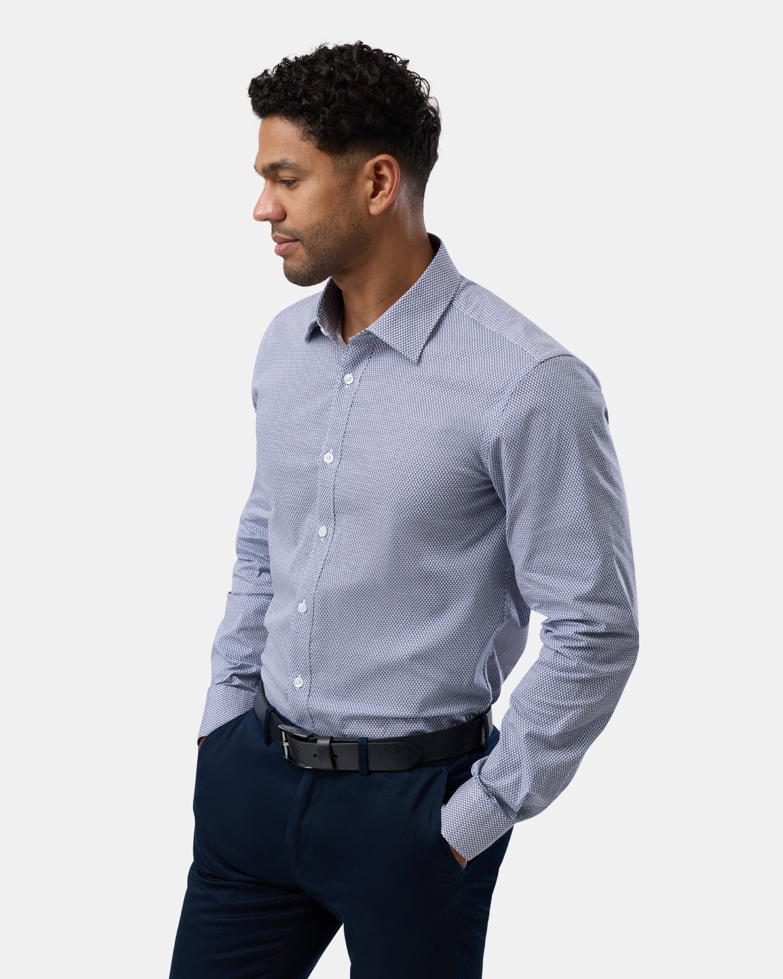 Angled view highlighting the side of the blue geometric performance shirt, stretch fabric visible