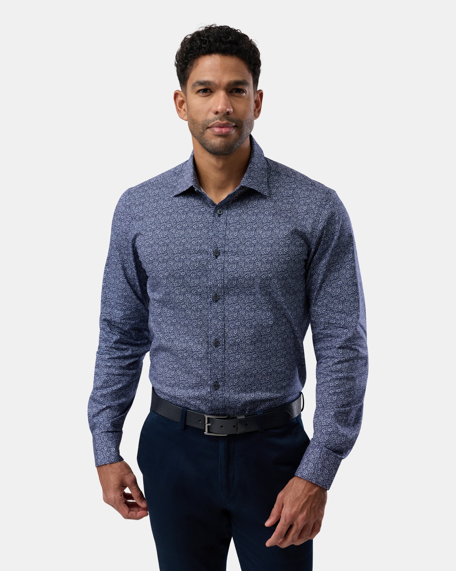 Man wearing navy floral stretch performance regular-fit shirt, seen from the front