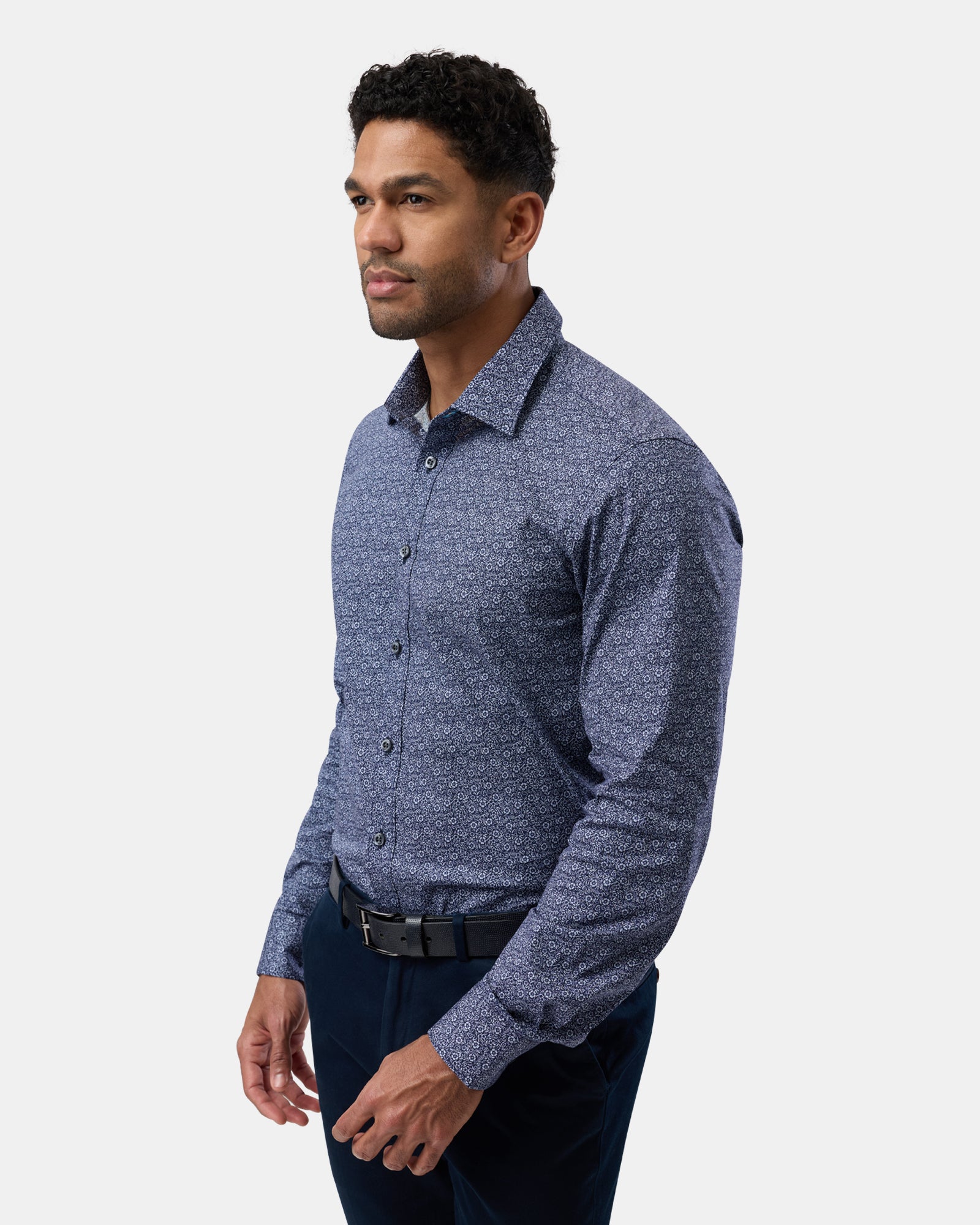 Side profile of man in navy floral stretch shirt