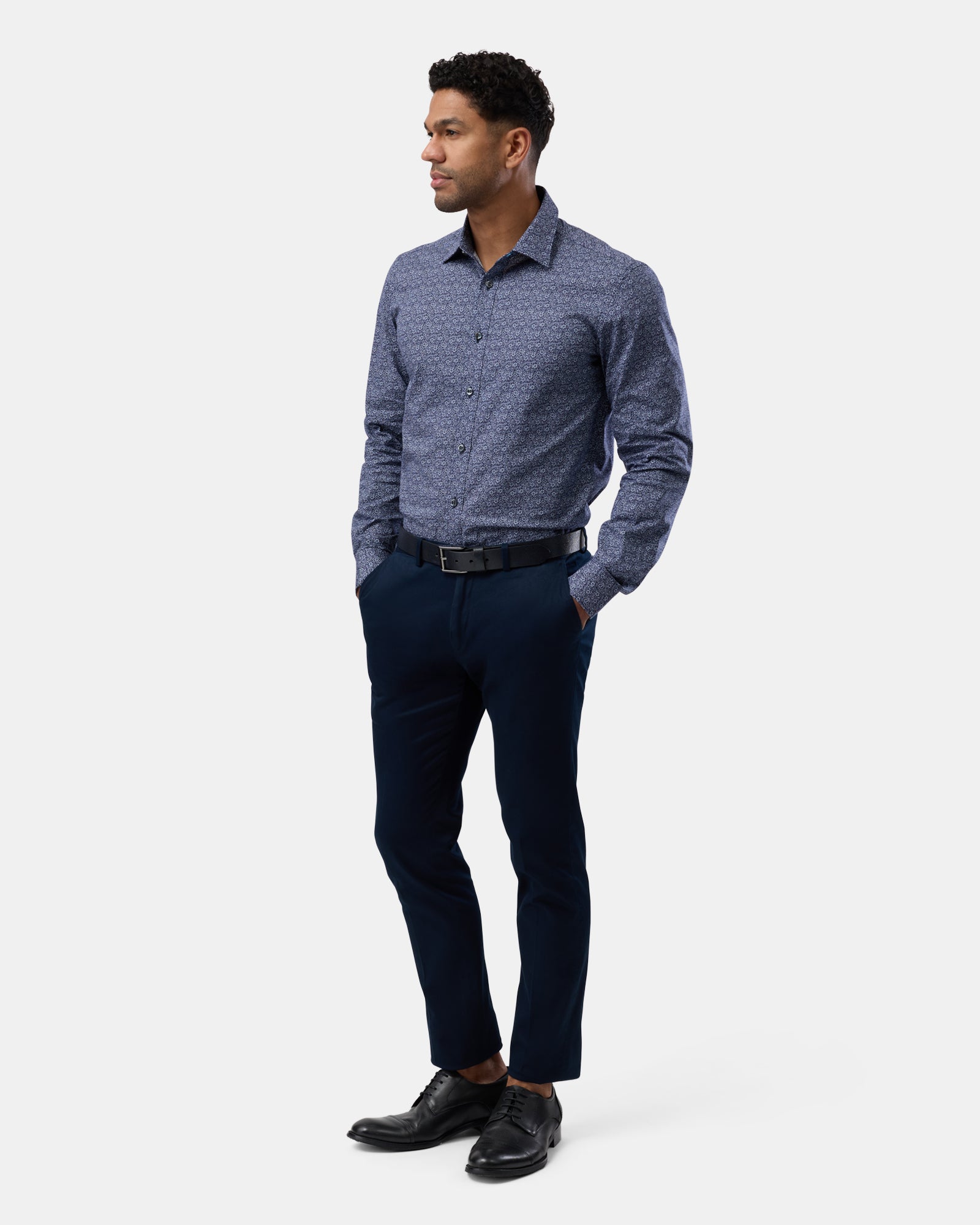 Full-length view of man wearing navy floral stretch performance shirt, complete outfit