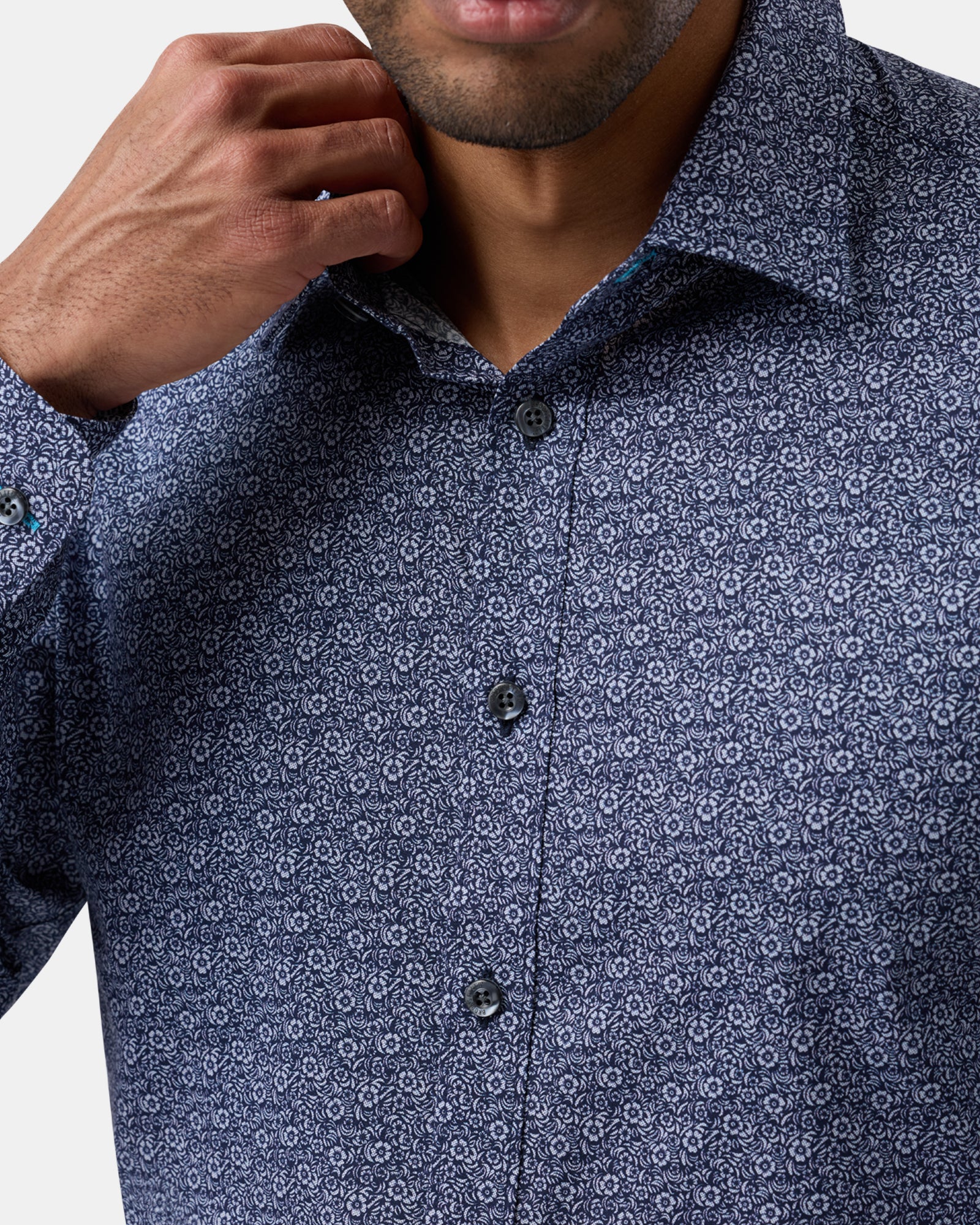 Close-up of navy floral stretch performance shirt, detailing fabric texture, pattern, and buttons