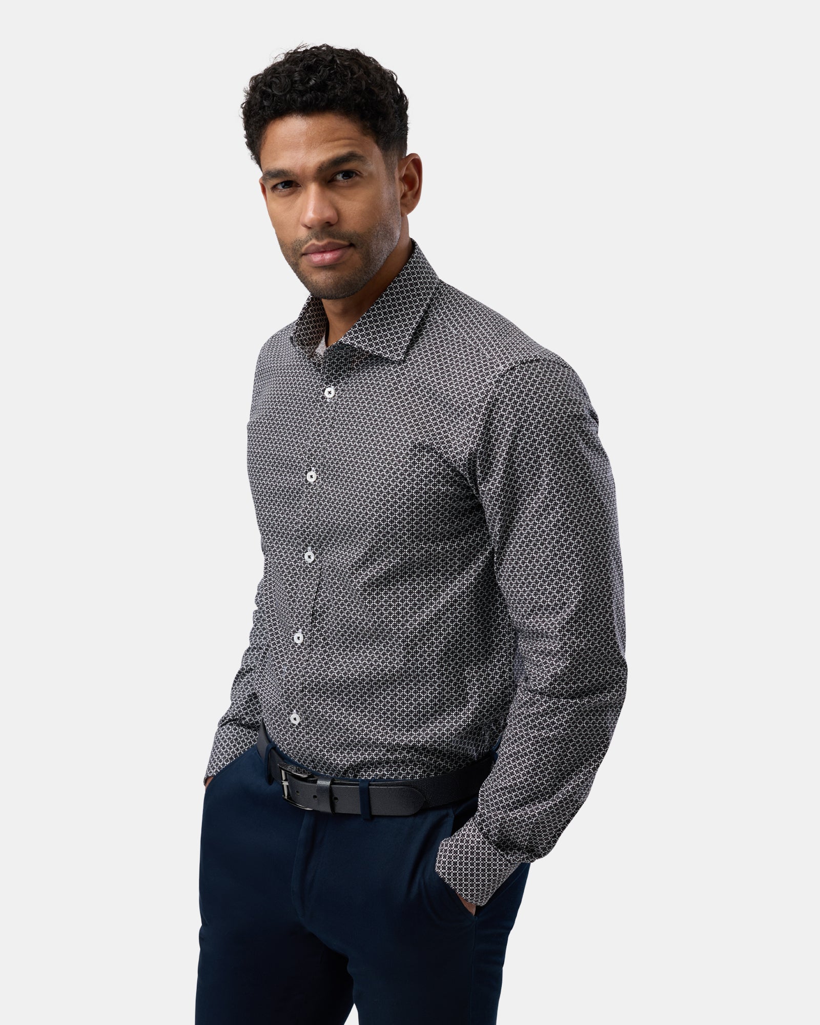 Angled view highlighting the side of the black patterned slim-fit shirt