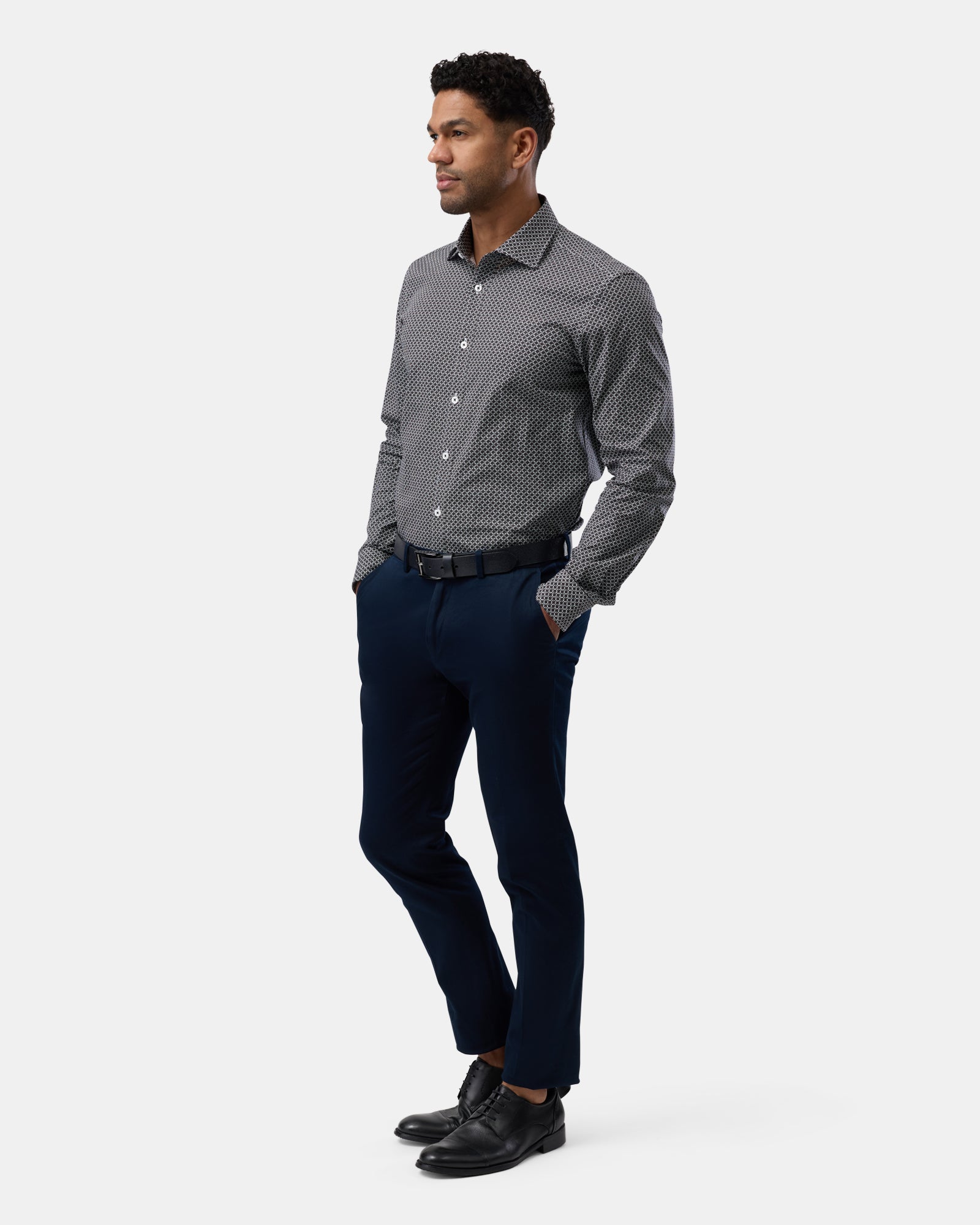 Entire outfit view featuring the black patterned shirt, professional modern style