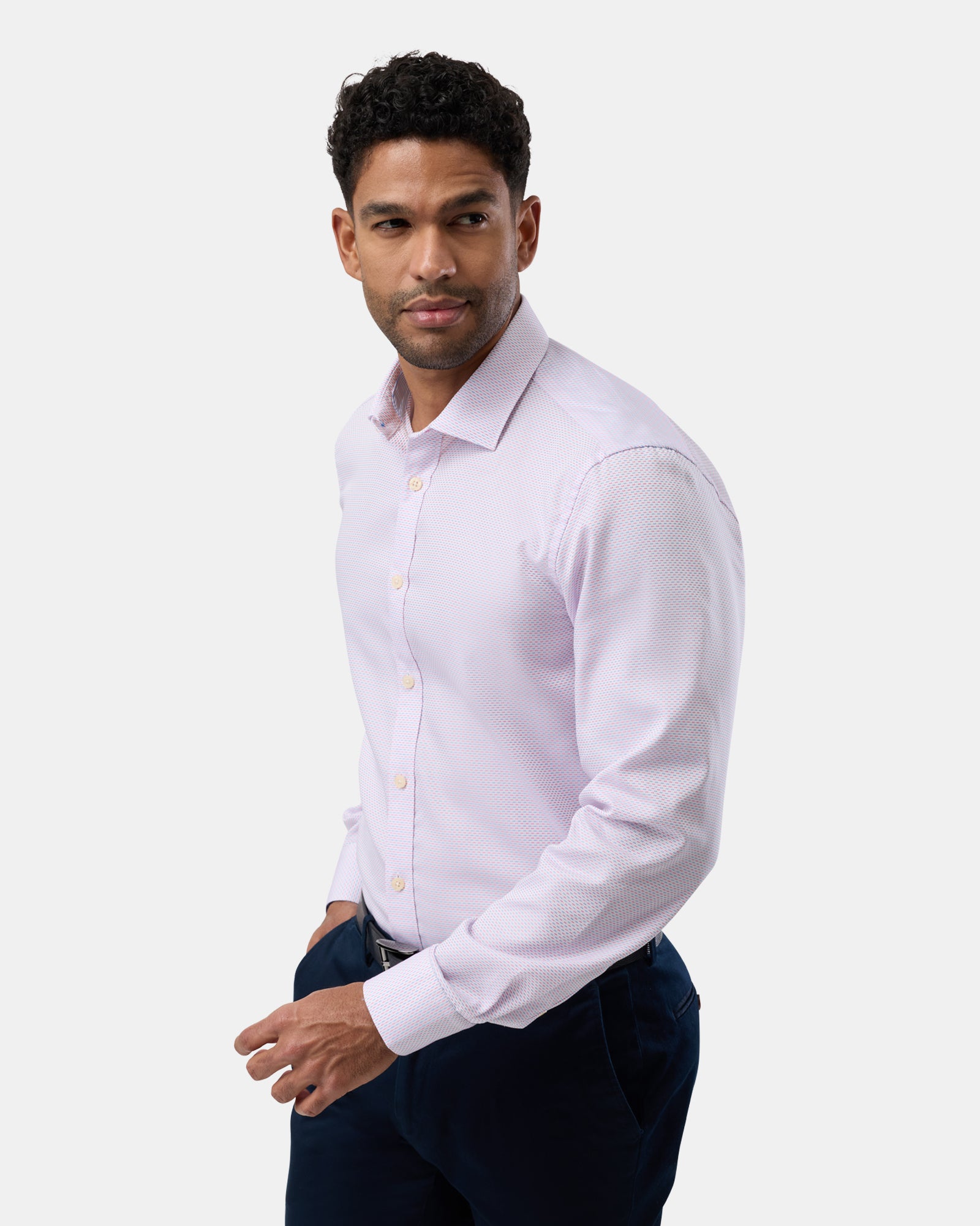 Side profile of man in pink patterned shirt, showing the slim tailored cut