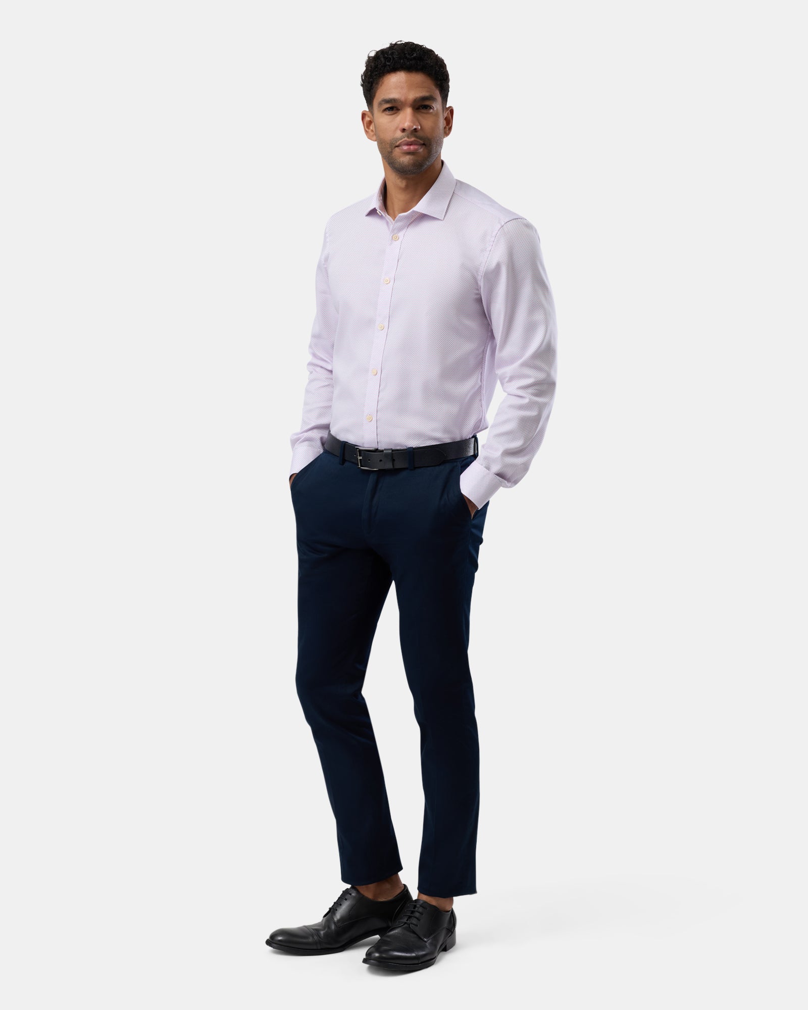 Full-length view of man wearing pink patterned slim-fit shirt, complete outfit