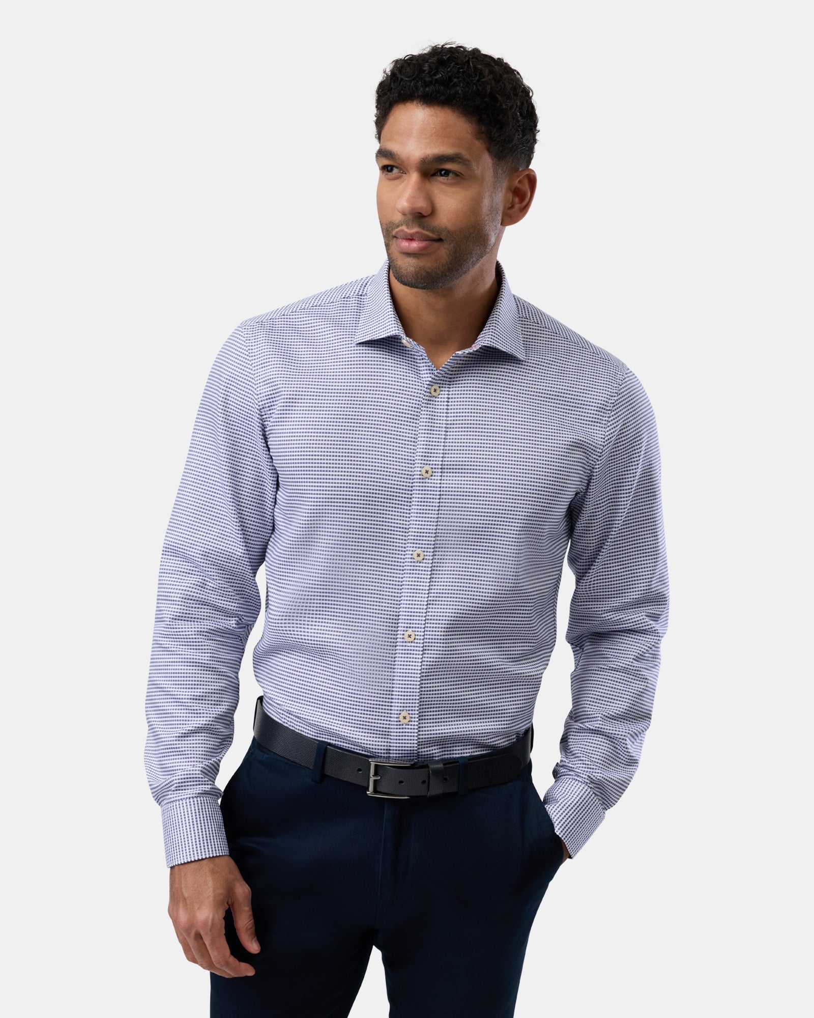 Front shot of man wearing blue slim-fit business shirt with subtle check pattern