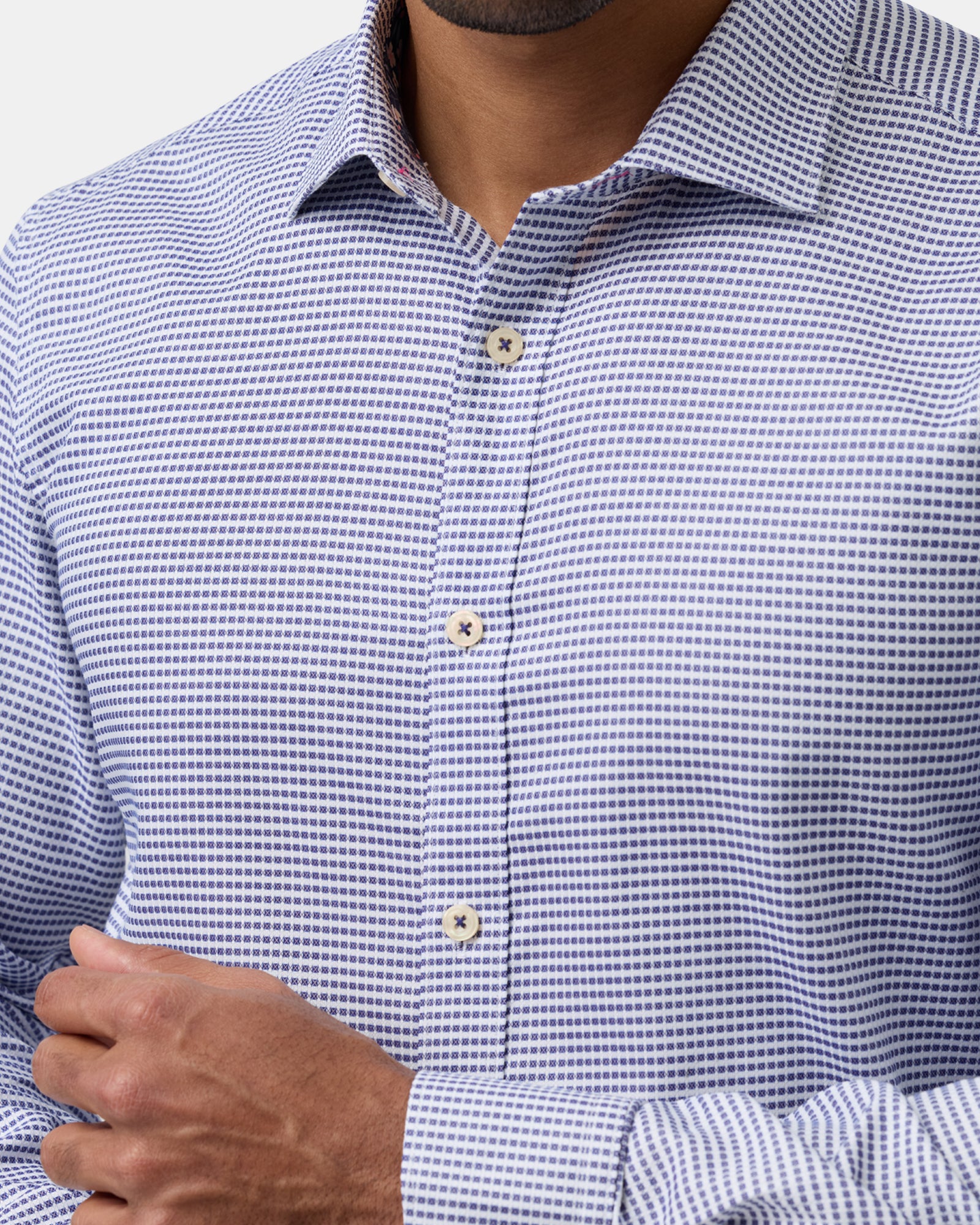 Detailed shot of blue checkered business shirt collar, stitching, and fabric texture