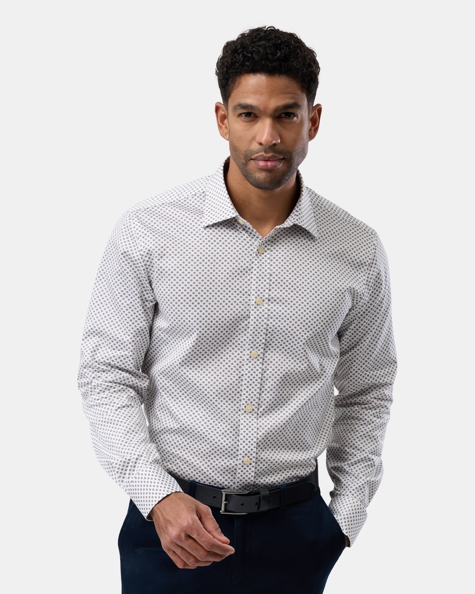 Front view of man wearing white slim-fit business shirt with subtle pattern