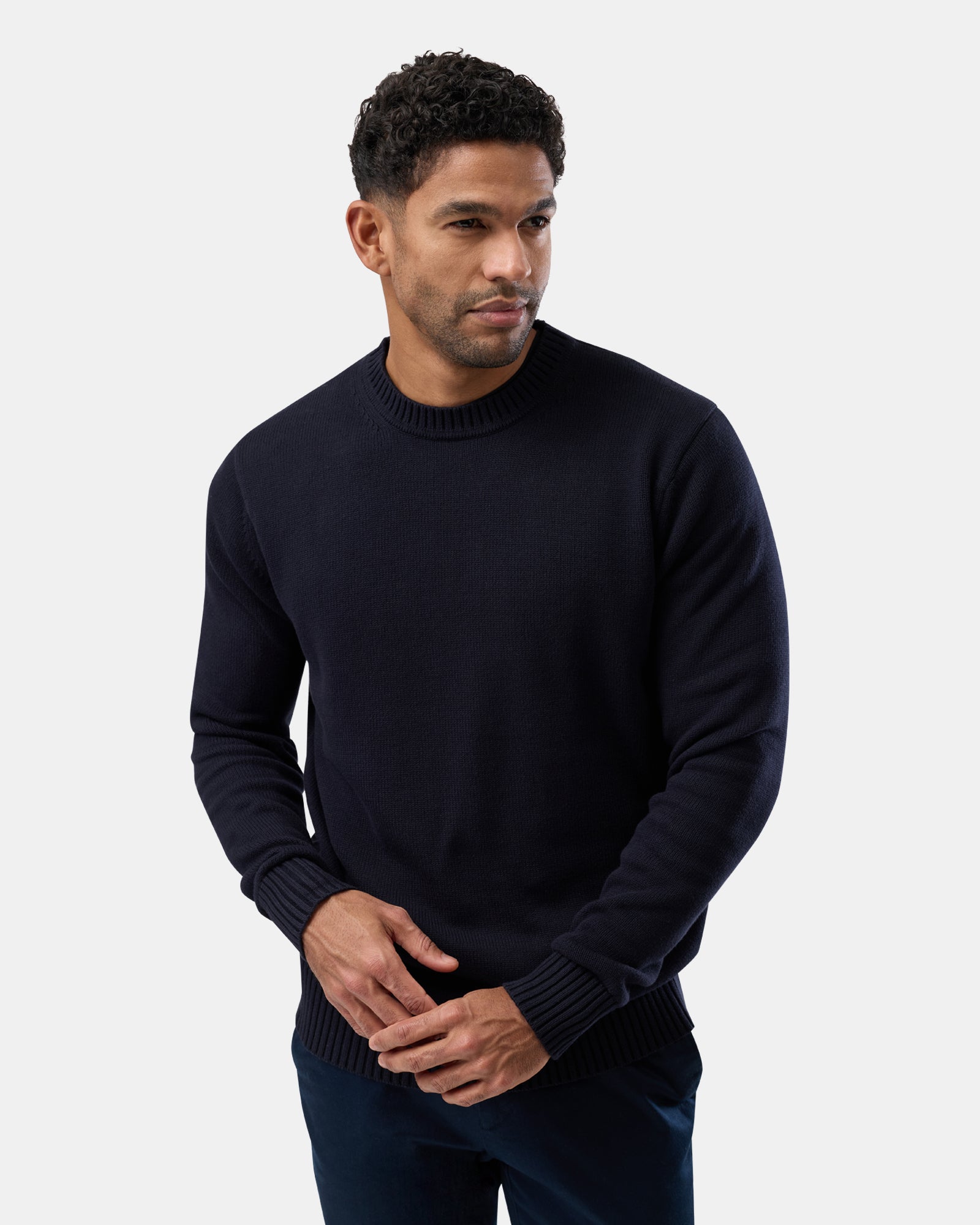 Person wearing Classic navy blue crew neck sweater