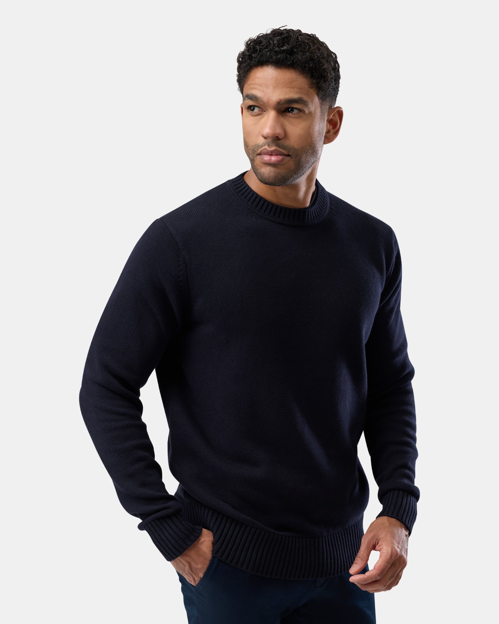 Modern menswear look with navy crew neck sweater