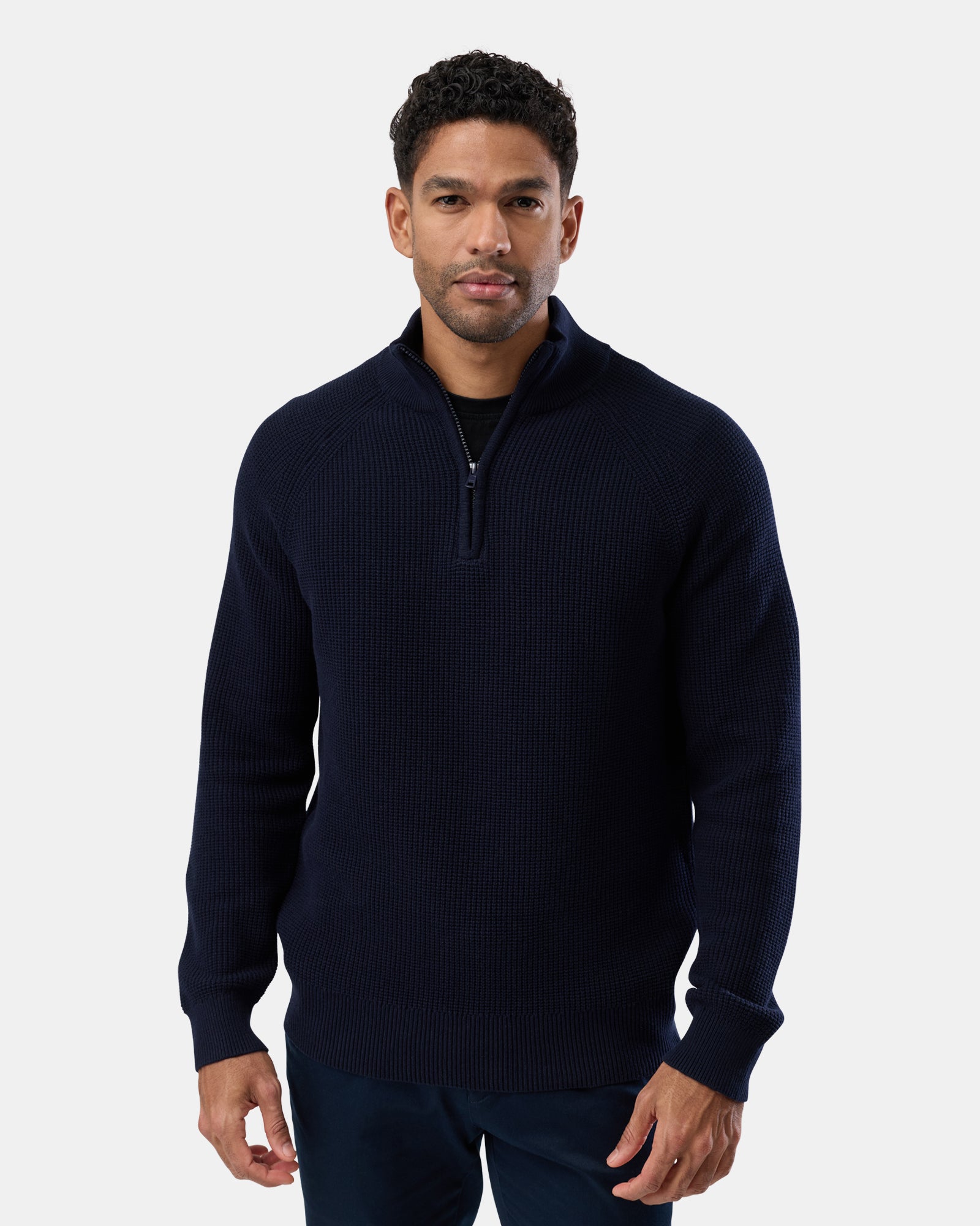 Man wearing a navy cotton half zip knit sweater