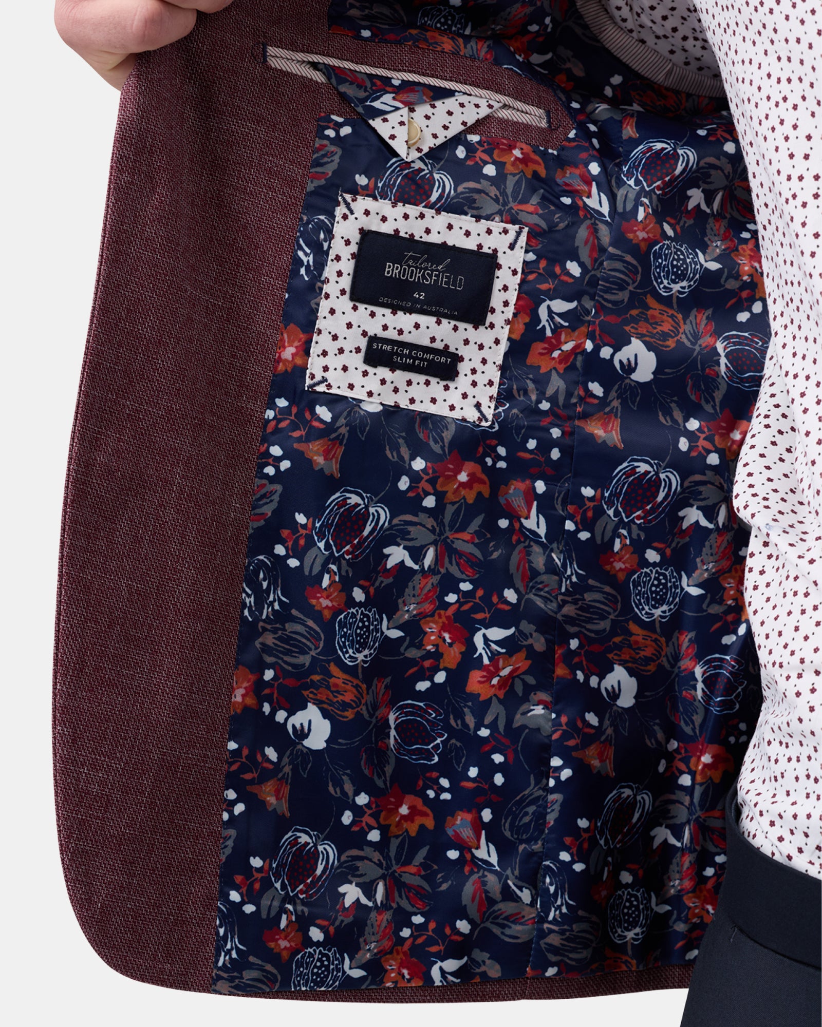 Detailed view of burgundy fully lined blazer lapel and fabric