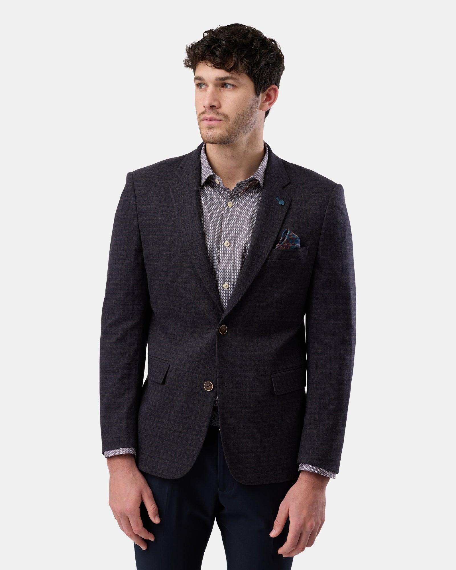 Front view of man wearing brown fully lined two-button blazer, slim fit