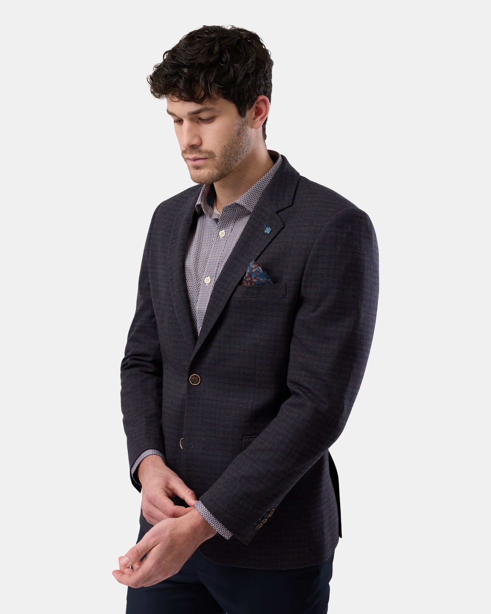 Side view of brown two-button blazer on man, structured silhouette