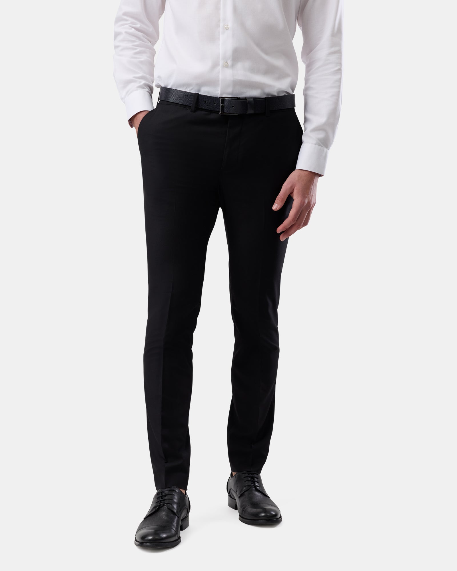 Front view of man wearing black tailored trousers, slim fit
