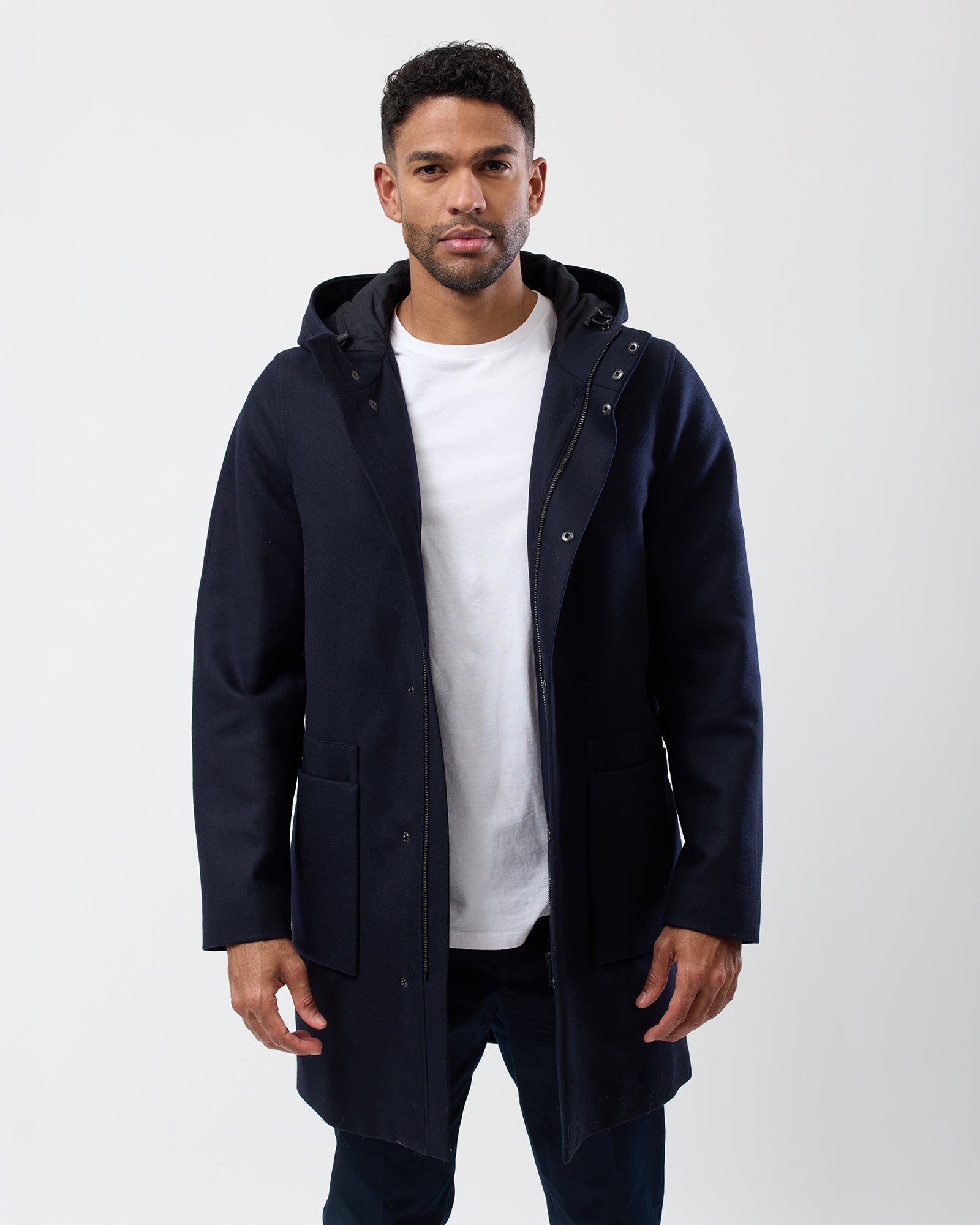 Man wearing navy hooded wool blend overcoat
