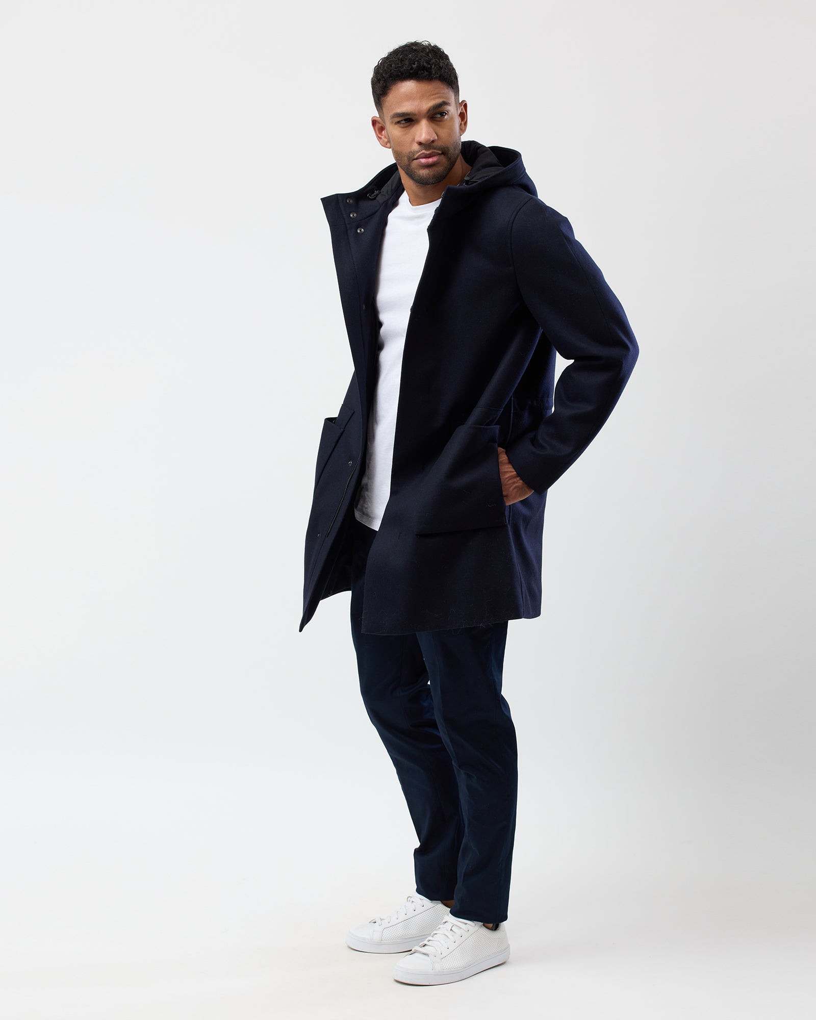 Full outfit view of navy hooded overcoat on male model