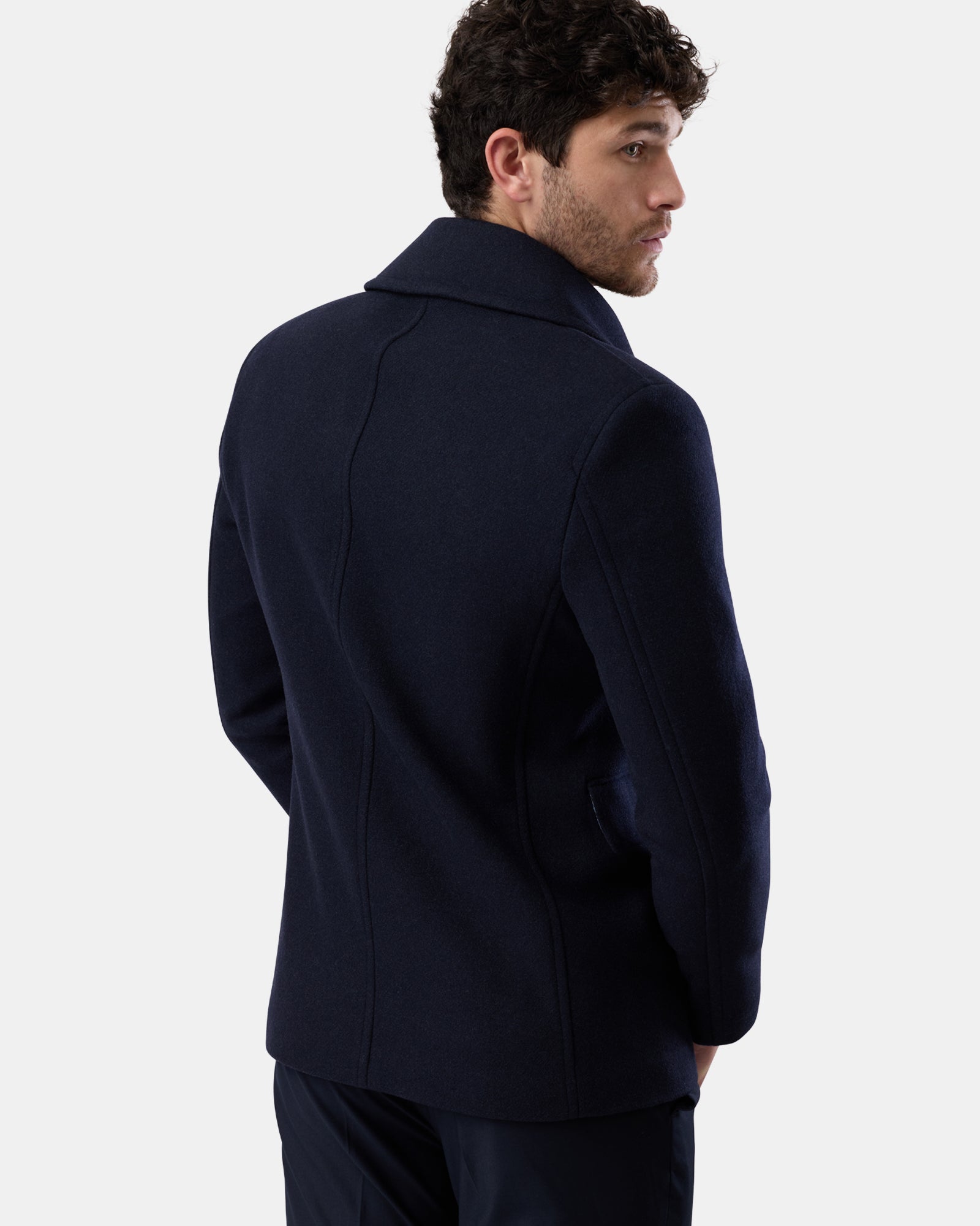 Navy wool blend peacoat on man, back angle